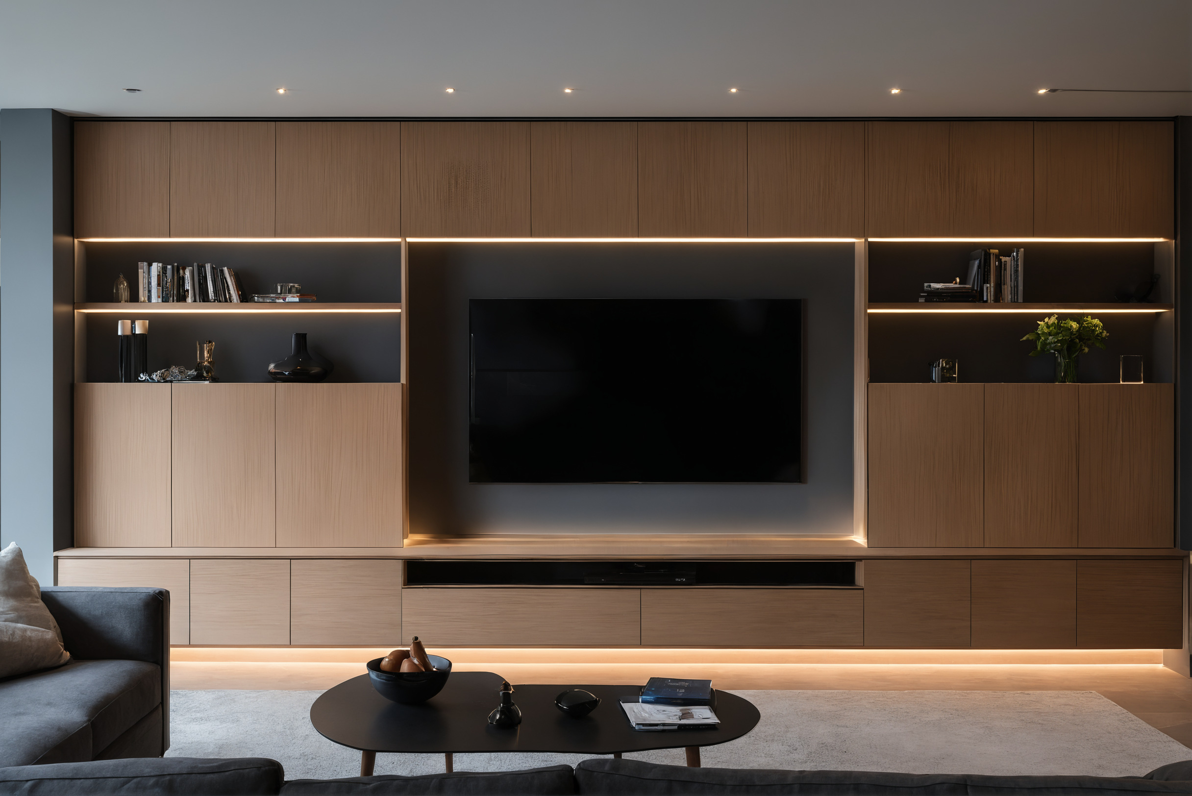 Built-in media wall with recessed television and closed cable cabinets